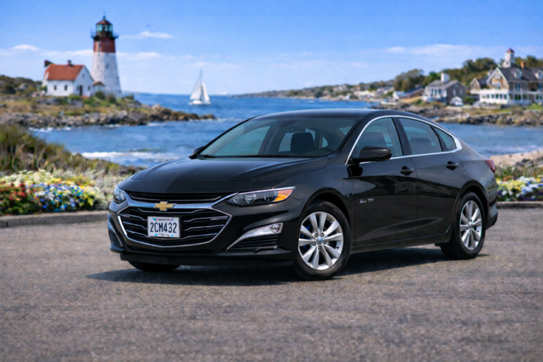 Black Chevrolet Malibu rental from Vachon in Cranston, RI, shown with a lighthouse and coastal backdrop