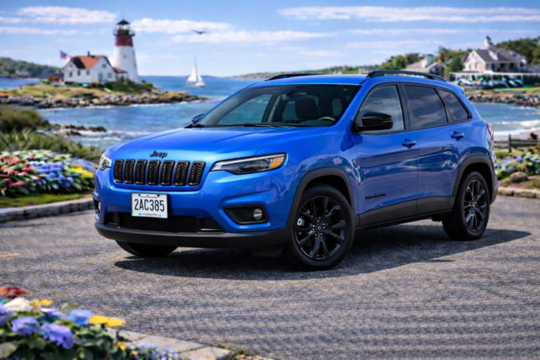 Blue Jeep Cherokee rental from Vachon in Cranston, RI, shown with a lighthouse and coastal backdrop