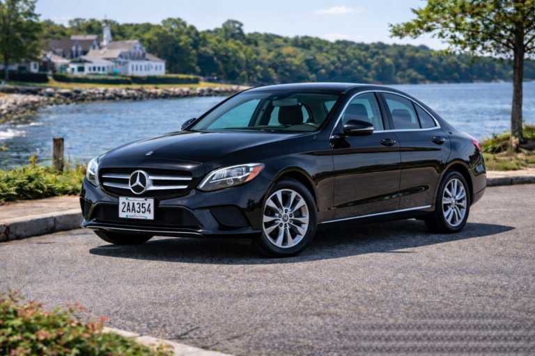 Black Mercedes-Benz C300 rental from Vachon in Cranston, RI, shown with a waterfront backdrop