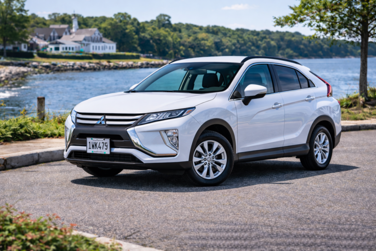 White Mitsubishi Eclipse Cross rental from Vachon in Cranston, RI, shown with a waterfront backdrop