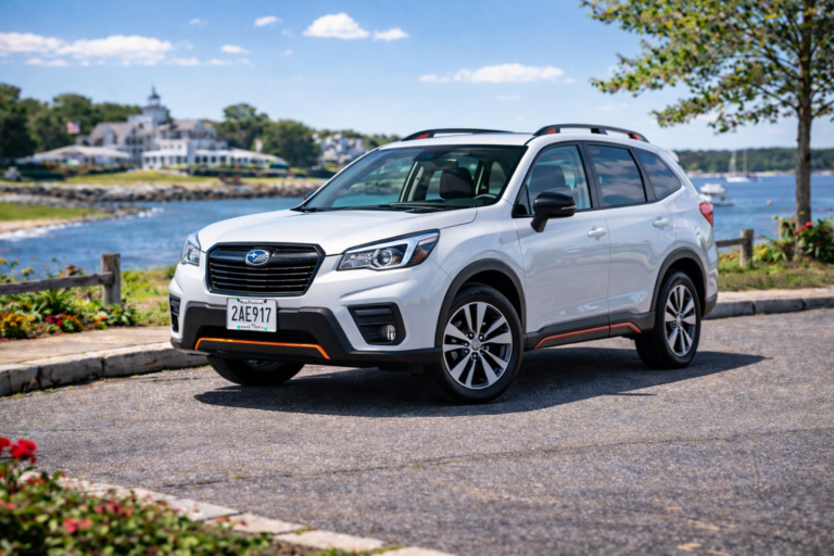 White Subaru Forester rental from Vachon in Cranston, RI, shown with a waterfront backdrop