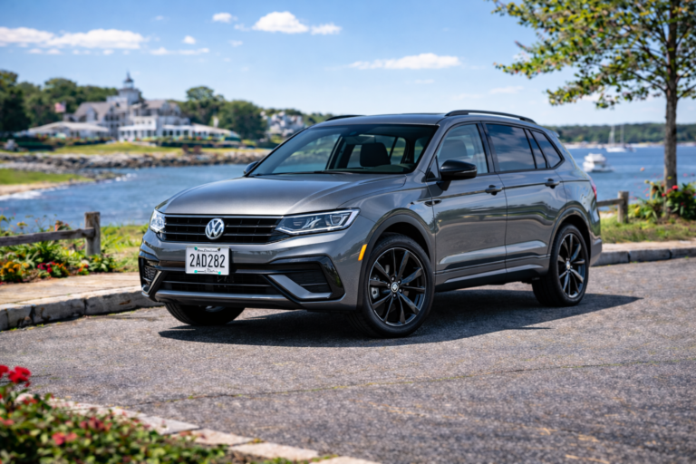 Gray Volkswagen Tiguan rental from Vachon in Cranston, RI, shown with a waterfront backdrop